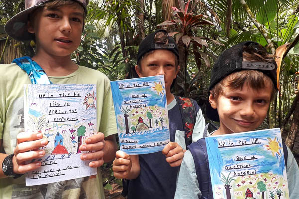 The Up in the Hill boys holding books that they made.