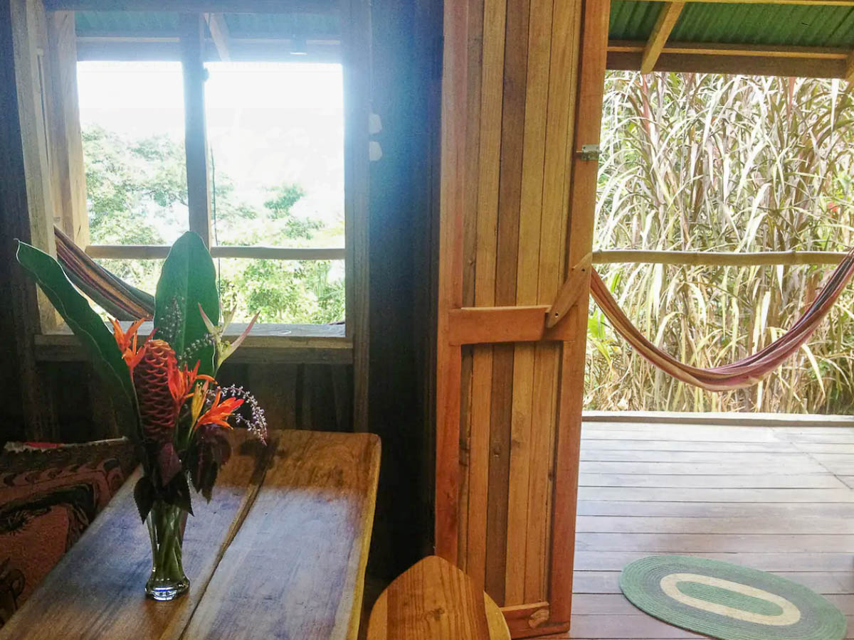A dining area with fresh flowers at the Pantai Cabin.
